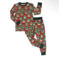 A two-piece children's pajama set laid flat on a white background, featuring a long-sleeve top and matching pants with a red holiday snow globe pattern and dark green trim.