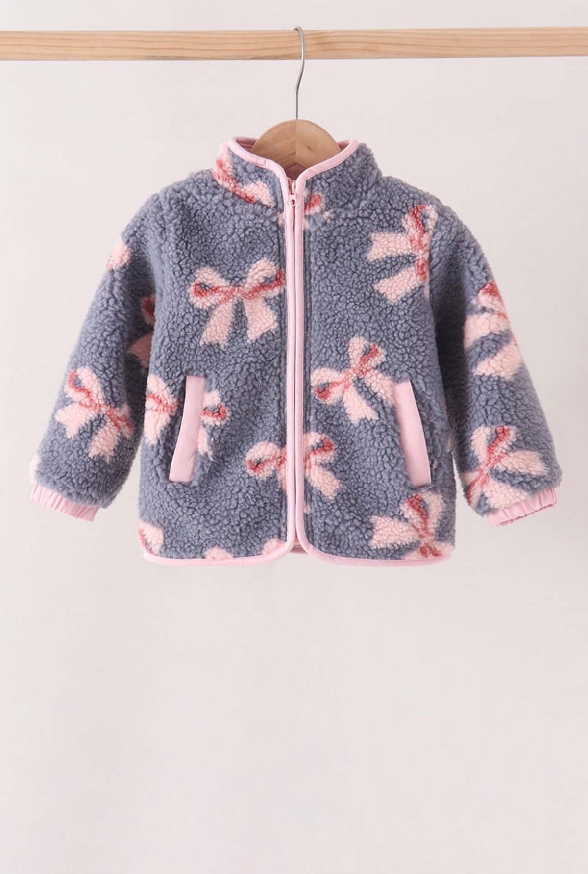 Blue Bow Fleece Jacket featuring a cozy design with charming bow patterns and soft fleece fabric.