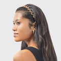 Woman with a decorative headband on a plain background