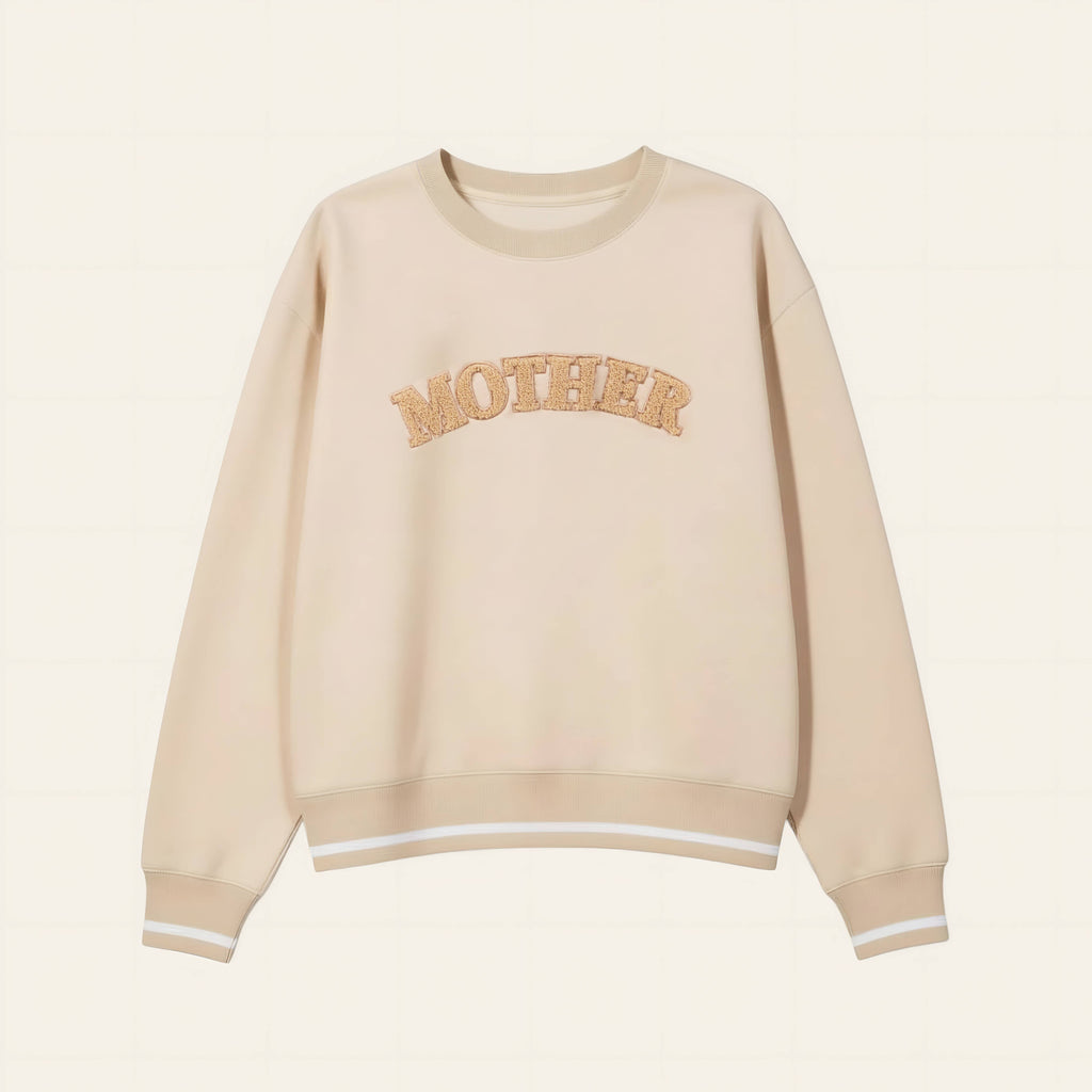 Beige sweatshirt with 'MOTHER' text on a beige background